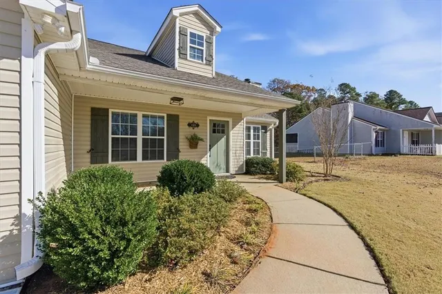 wooden floor fireplace and windows in an empty room