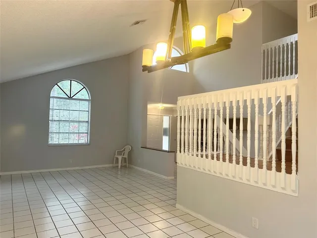 a view of a livingroom with wooden floor and a window
