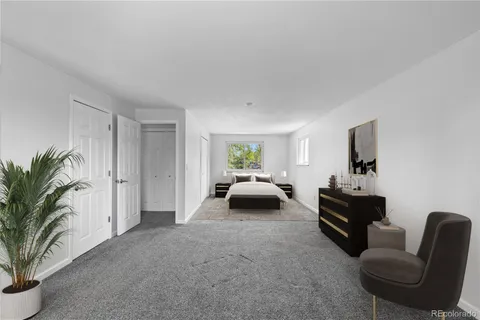 a bedroom with furniture and a potted plant