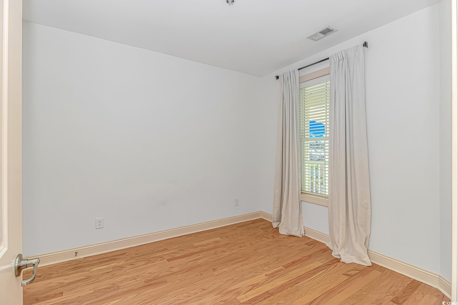 128 Puffin Drive, Unit 3A Pawleys Island, SC 29585 - Photo 12 of 30 room featuring light wood-style floors and baseboards