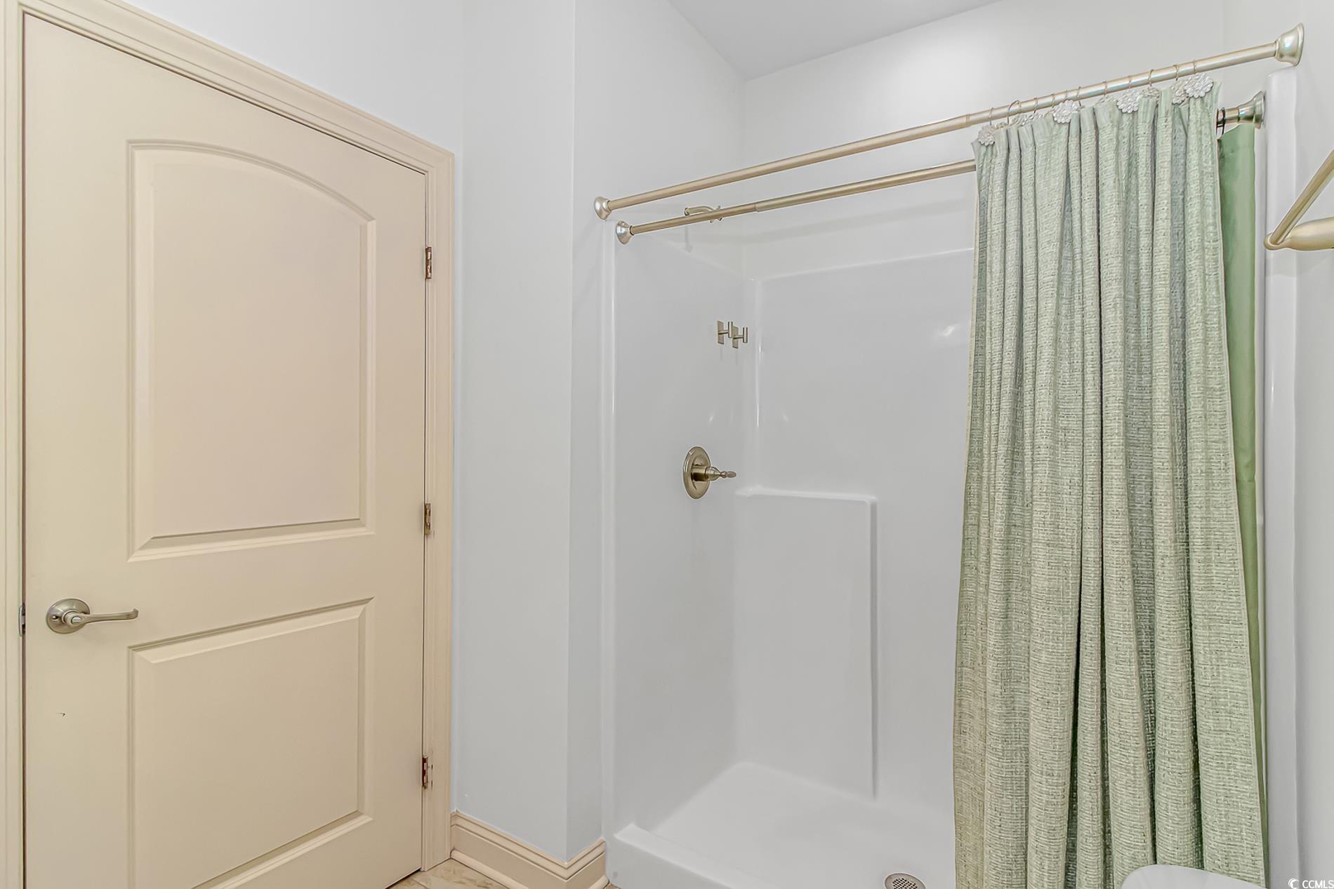 128 Puffin Drive, Unit 3A Pawleys Island, SC 29585 - Photo 25 of 30 Full bath featuring a shower stall and baseboards