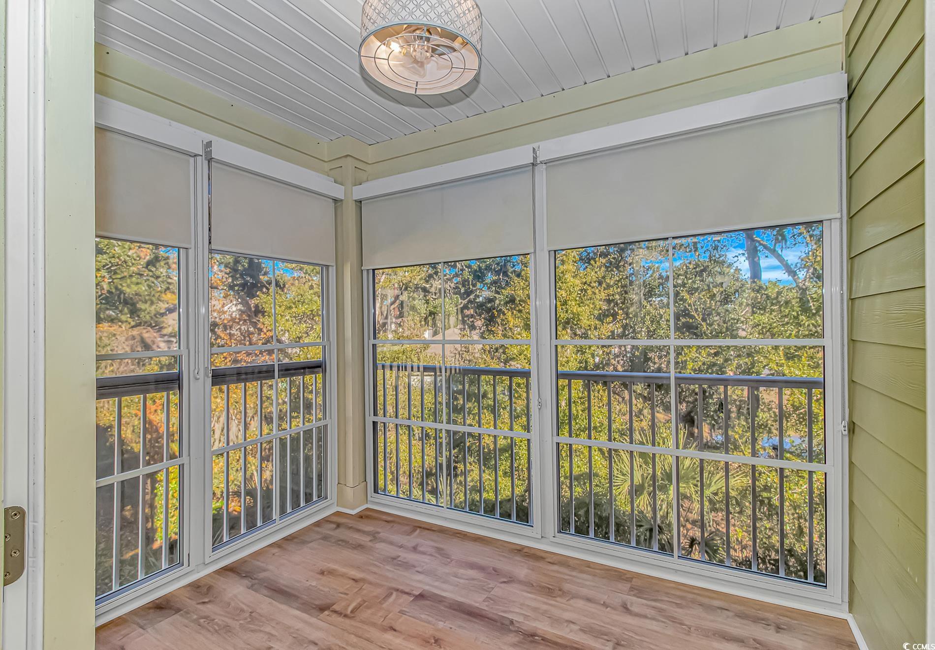 128 Puffin Drive, Unit 3A Pawleys Island, SC 29585 - Photo 26 of 30 sunroom with wood finished floors