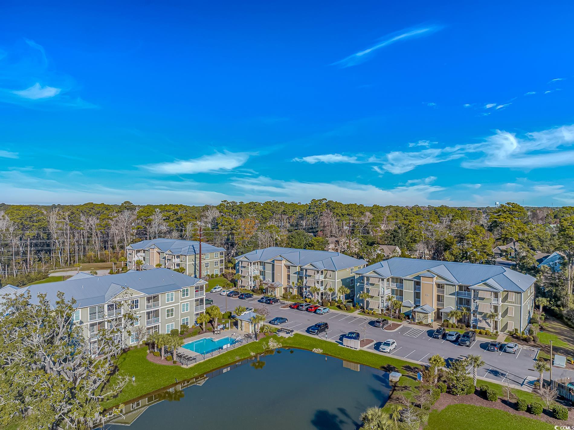 128 Puffin Drive, Unit 3A Pawleys Island, SC 29585 - Photo 4 of 30 Aerial view of a nearby body of water and a pool area