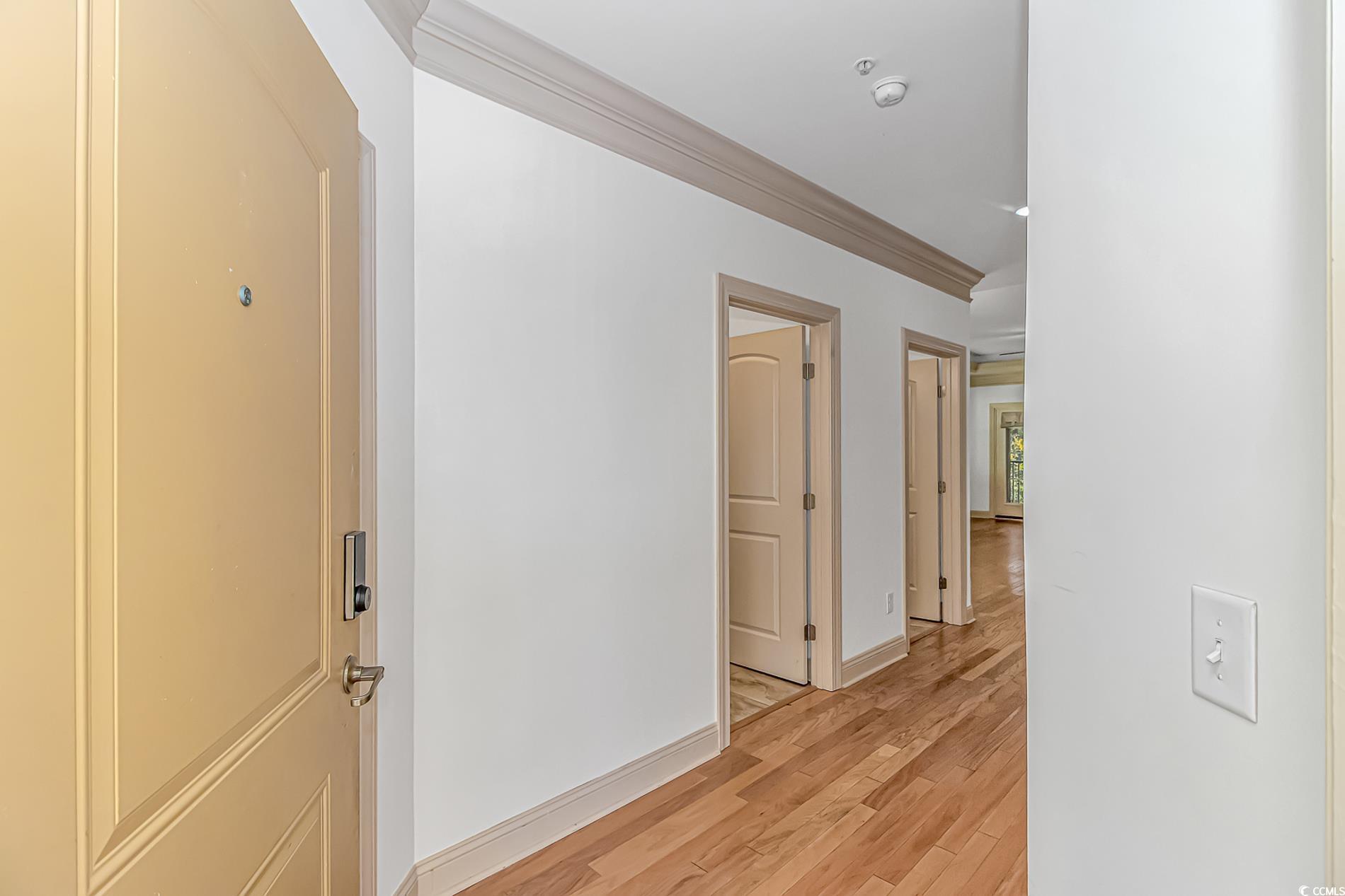 128 Puffin Drive, Unit 3A Pawleys Island, SC 29585 - Photo 7 of 30 Hallway featuring ornamental molding and light wood-style flooring