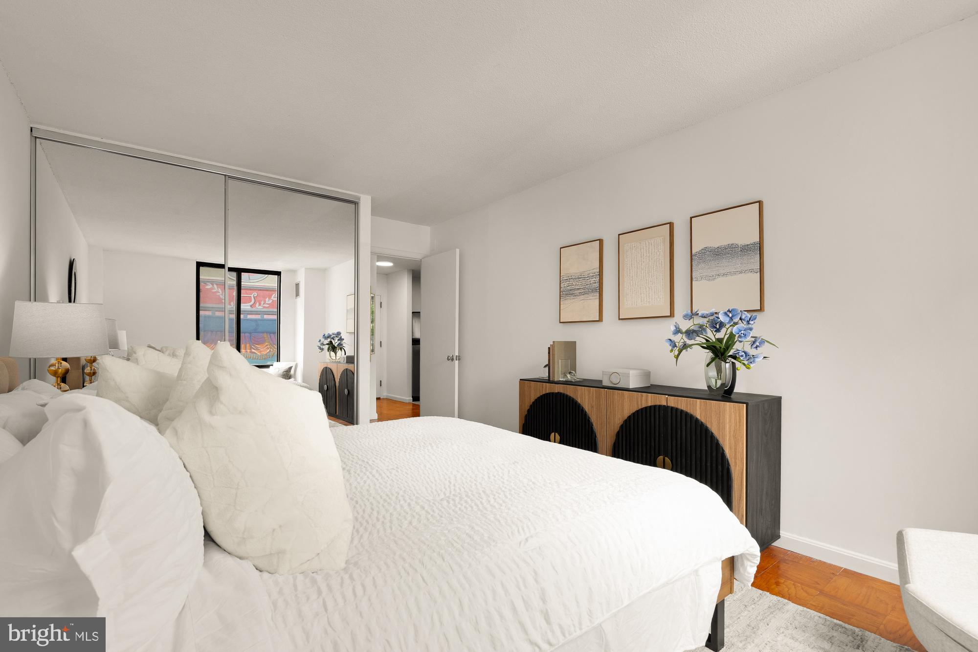 1301 20th Street Northwest, Unit 312 Washington, DC 20036 - Photo 20 of 31 a bedroom with a bed and a chandelier