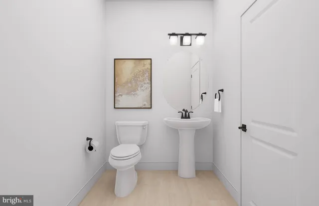 a bathroom with a toilet sink and mirror
