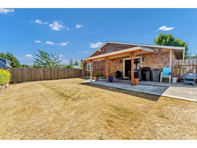 a view of a white house with a swimming pool