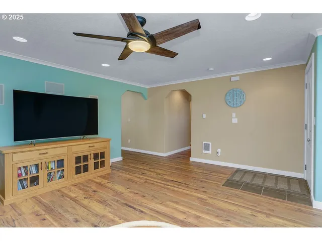 a view of an empty room with wooden floor