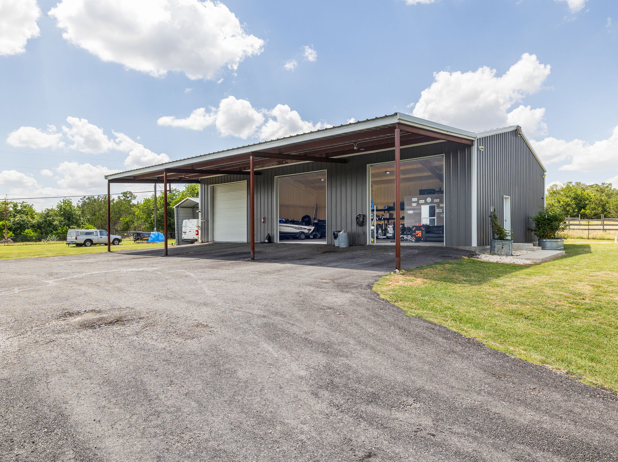 3001 County Road 255 Georgetown, TX 78633 - Photo 6 of 35 The versatile 40’ x 60’ metal workshop offers ample covered parking and garage bays with roll-up doors.