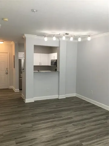 a view of a room with wooden floor and staircase