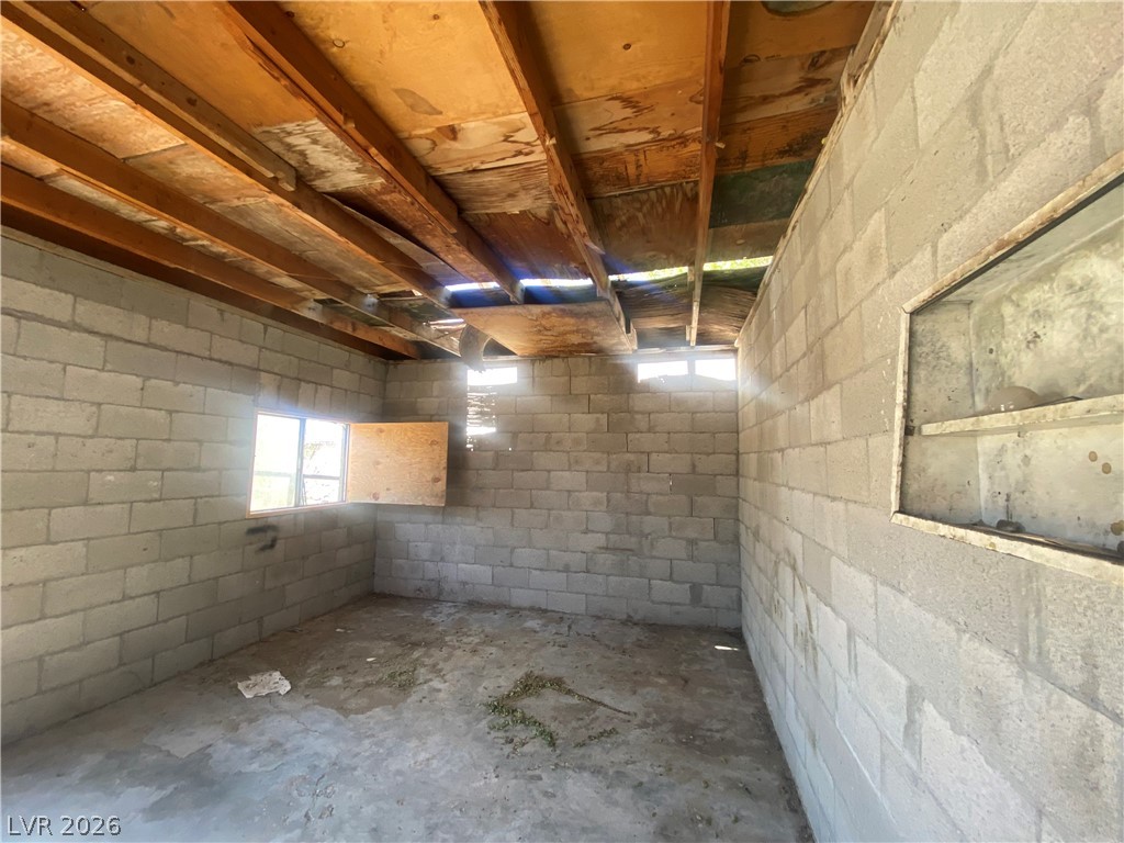 701 3rd Street Gabbs, NV 89409 - Photo 8 of 10 Concrete block walls and an exposed wood ceiling define this unfinished space.