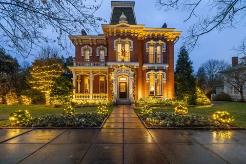 a view of a brick house with many windows