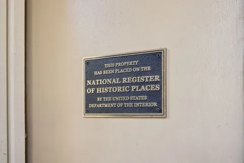 a view of a dining room with furniture a chandelier and wooden floor