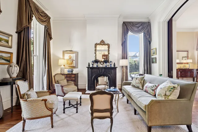 a living room with furniture fireplace and a large window
