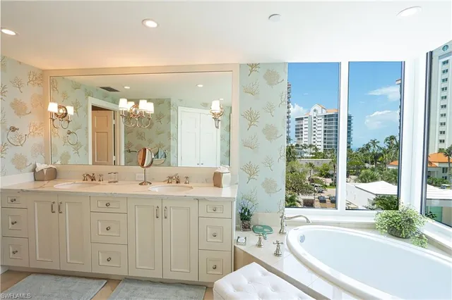 a spacious bathroom with a granite countertop sink mirror and a bathtub