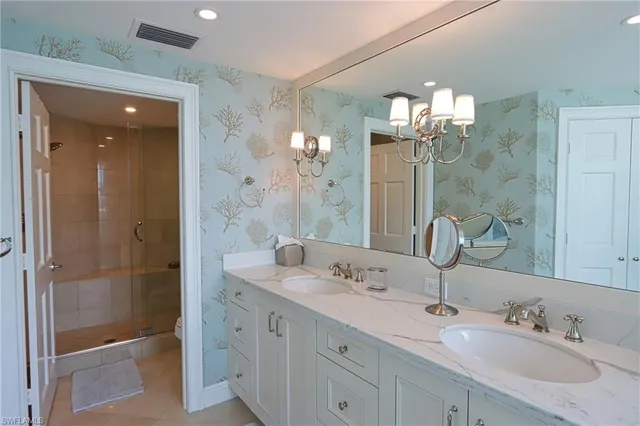 a bathroom with double sink and a mirror