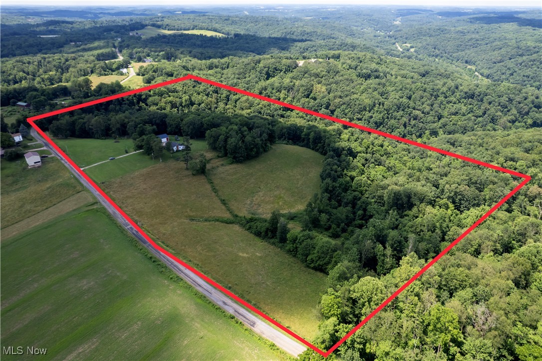 1292 Cinder Road Southeast Carrollton, OH 44615 - Photo 9 of 42 Aerial view of sparsely populated area featuring a heavily wooded area and property parcel outlined