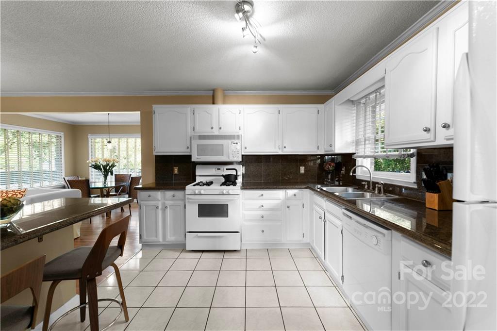 1705 Tyvola Road Charlotte, NC 28210 - Photo 14 of 40 a kitchen with white cabinets appliances and a window