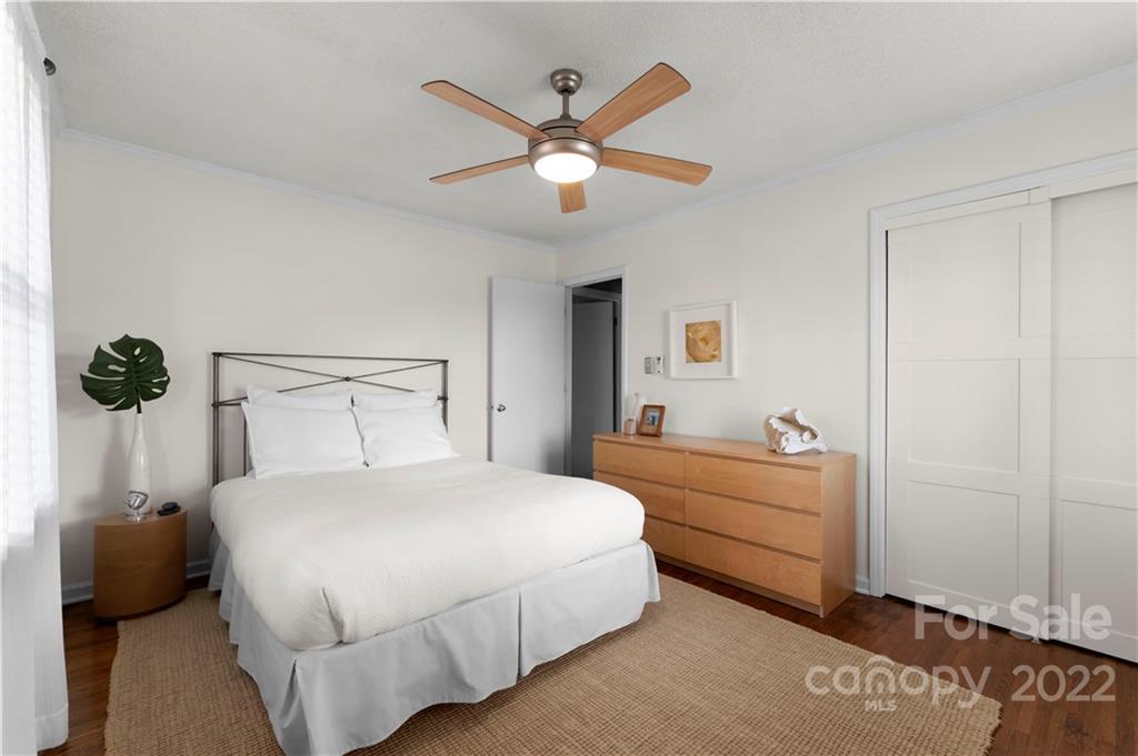 1705 Tyvola Road Charlotte, NC 28210 - Photo 17 of 40 a bedroom with a bed and a chandelier