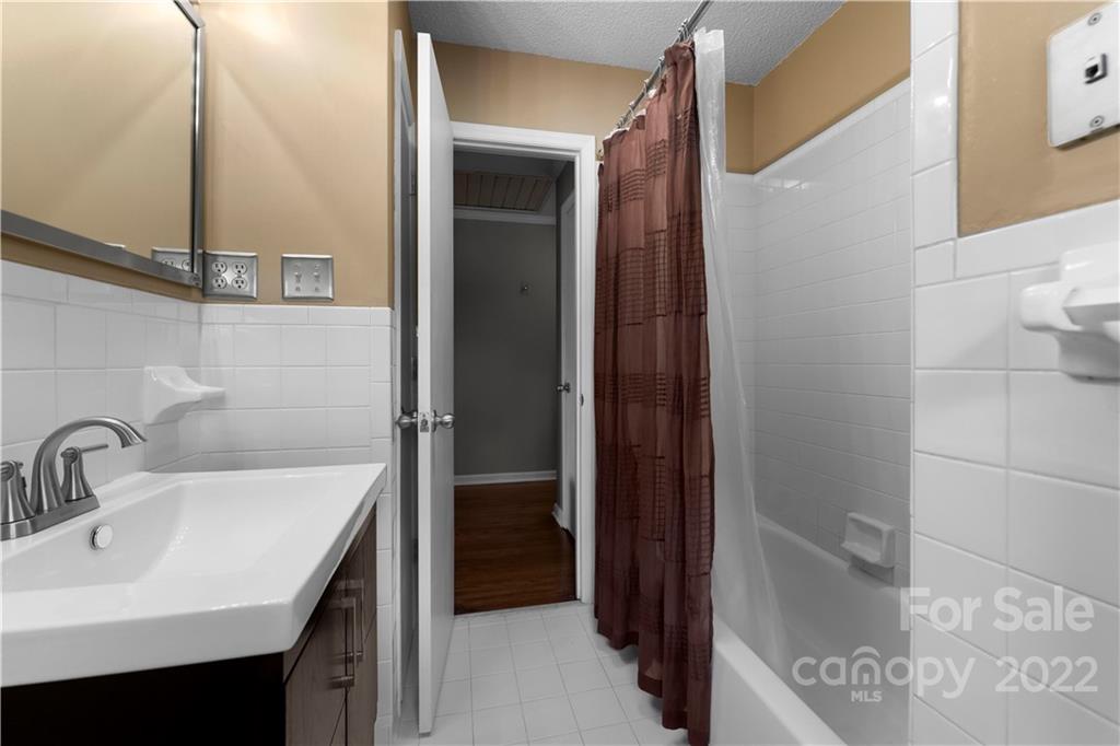 1705 Tyvola Road Charlotte, NC 28210 - Photo 21 of 40 a bathroom with a sink and a mirror
