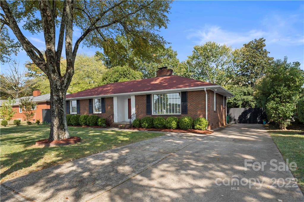 1705 Tyvola Road Charlotte, NC 28210 - Photo 4 of 40 a front view of a house with a yard and potted plants
