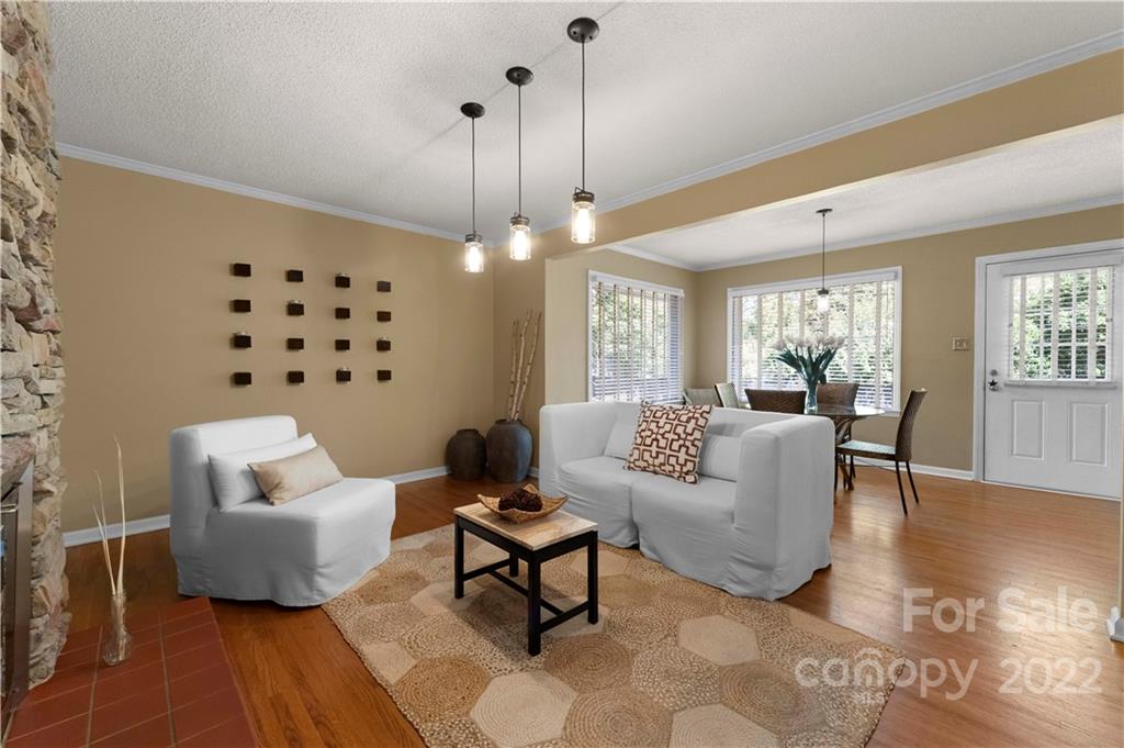 1705 Tyvola Road Charlotte, NC 28210 - Photo 5 of 40 a living room with furniture and a chandelier