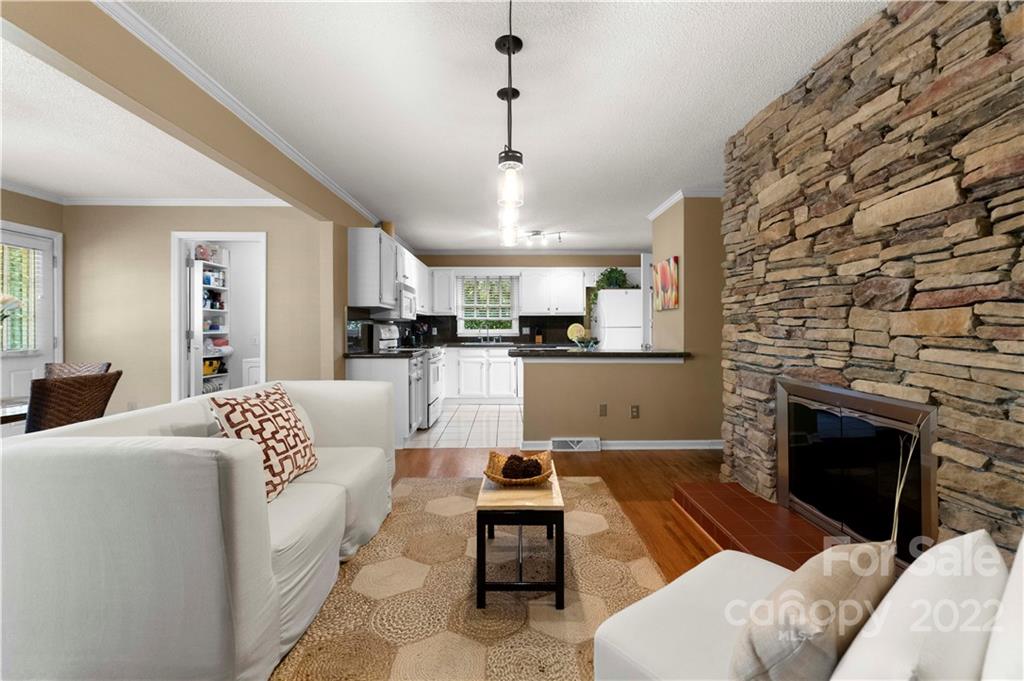 1705 Tyvola Road Charlotte, NC 28210 - Photo 6 of 40 a living room with furniture and a fireplace