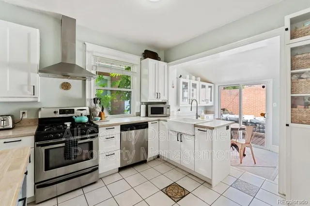 a kitchen with appliances cabinets and a stove top oven