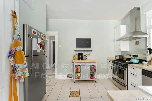 a kitchen with stainless steel appliances granite countertop a refrigerator and a stove