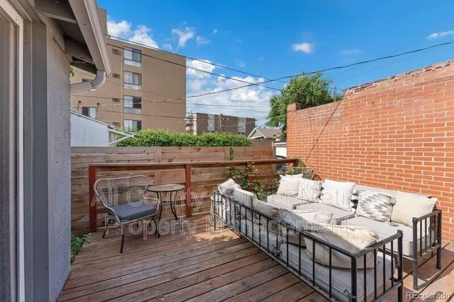 a balcony with furniture and wooden floor