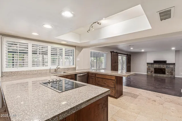 a kitchen with a stove a refrigerator and a sink