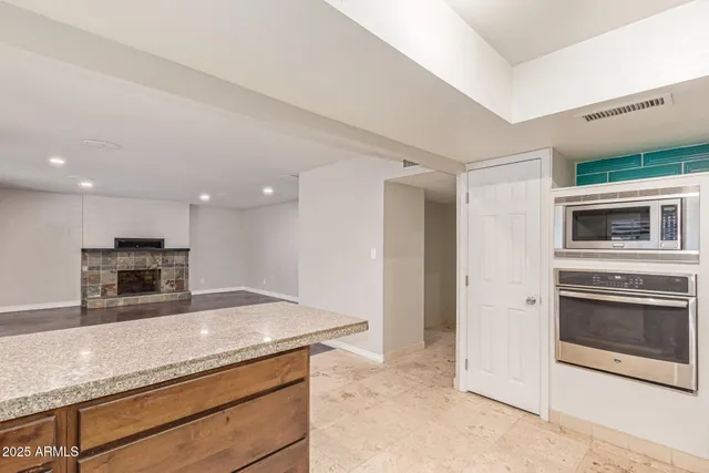 a kitchen with stainless steel appliances granite countertop a sink and a microwave