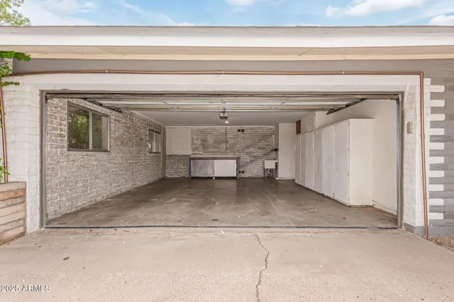 a view of a patio with a table and chairs under an umbrella