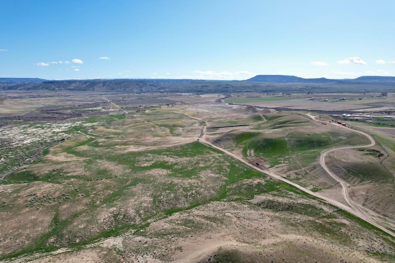 1777 9 Road Mack, CO 81525 - Photo 17 of 34 a view of a backyard with wooden floor and a mountain view