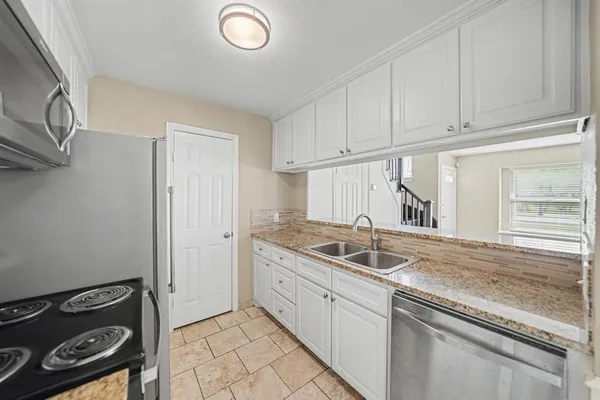 a kitchen with a sink and cabinets