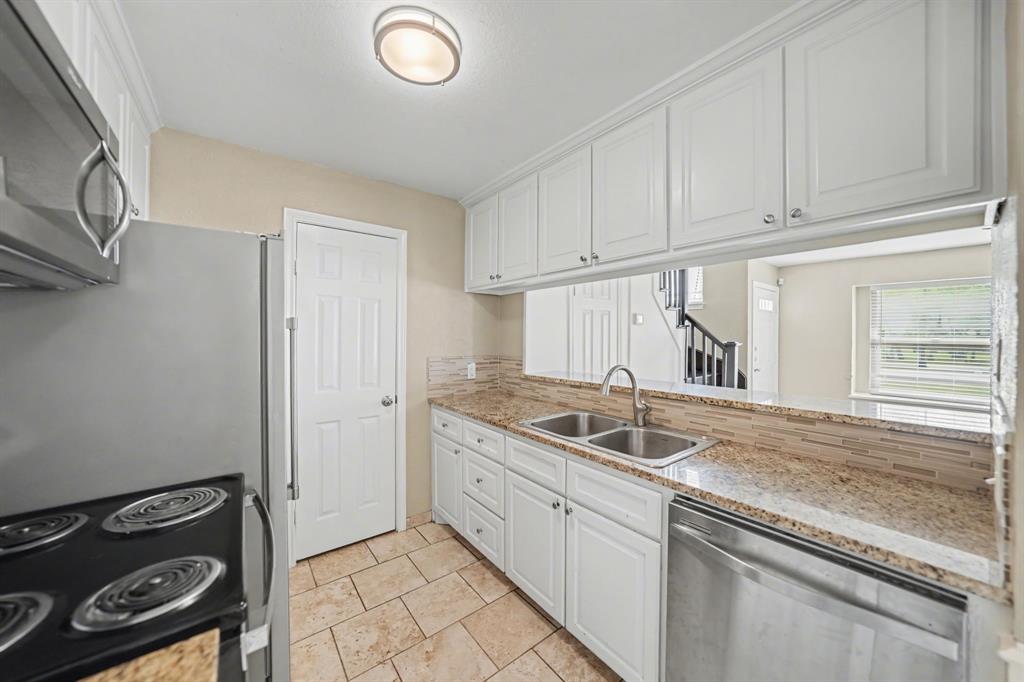 6925 Calender Road, Unit A Arlington, TX 76001 - Photo 13 of 19 a kitchen with a sink and cabinets