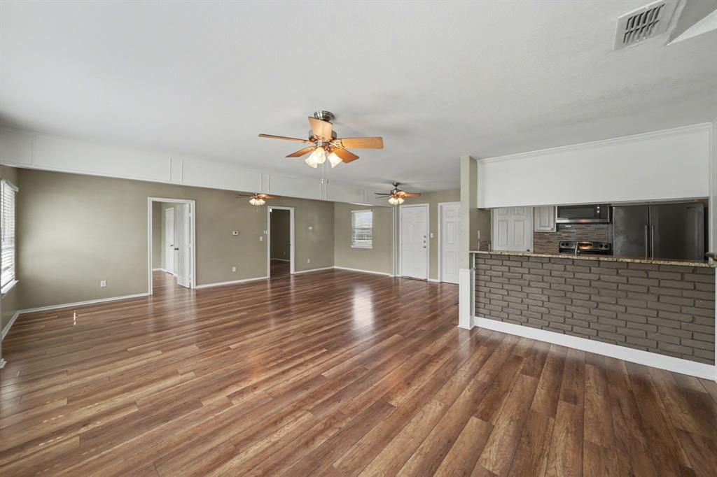 6925 Calender Road, Unit A Arlington, TX 76001 - Photo 6 of 19 wooden floor in an empty room with a window