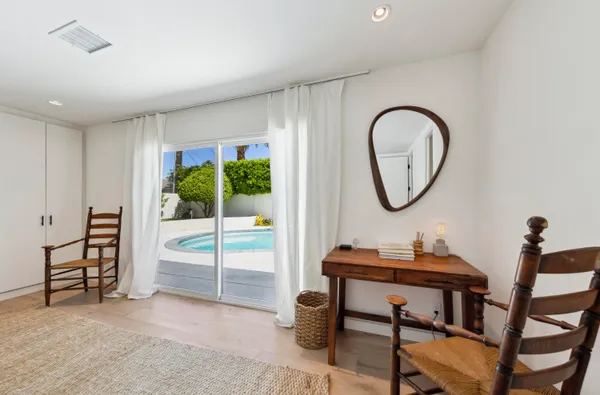 a bedroom with a bed and a table