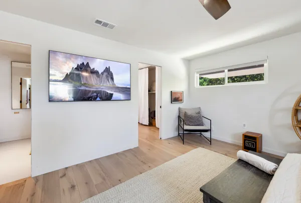 a living room with a bed furniture and a window