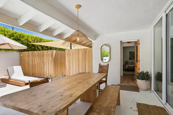 a balcony with a table and chairs