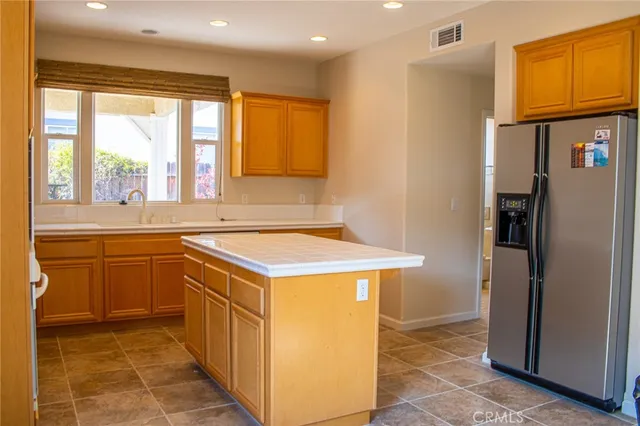 a kitchen with stainless steel appliances granite countertop a sink and a cabinets