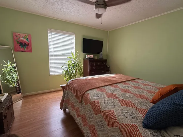 a bedroom with a bed and a flat screen tv