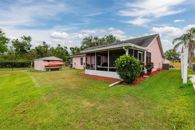 a living room with furniture and floor to ceiling windows