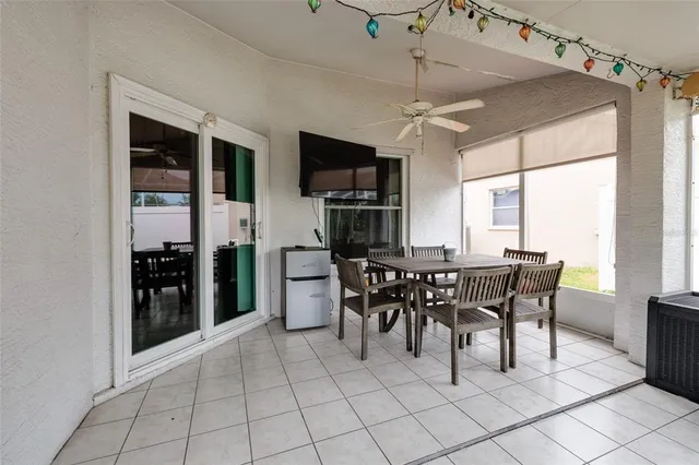 a living room with patio furniture and a large window