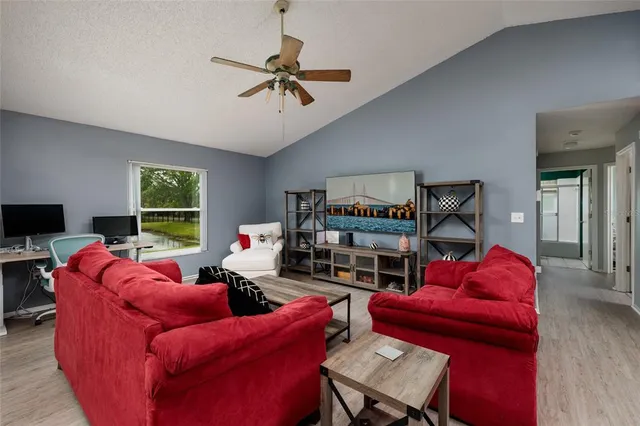 a living room with furniture a red rug and a window