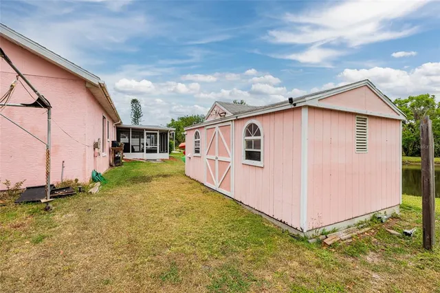 a backyard of a house with yard and outdoor seating
