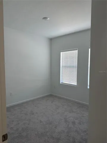 a bathroom with a granite countertop toilet a sink and a mirror