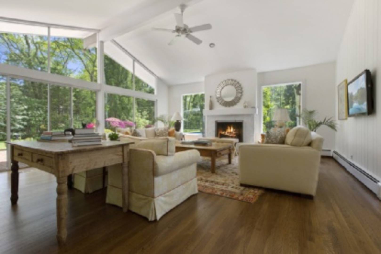 a living room with furniture fireplace and a large window