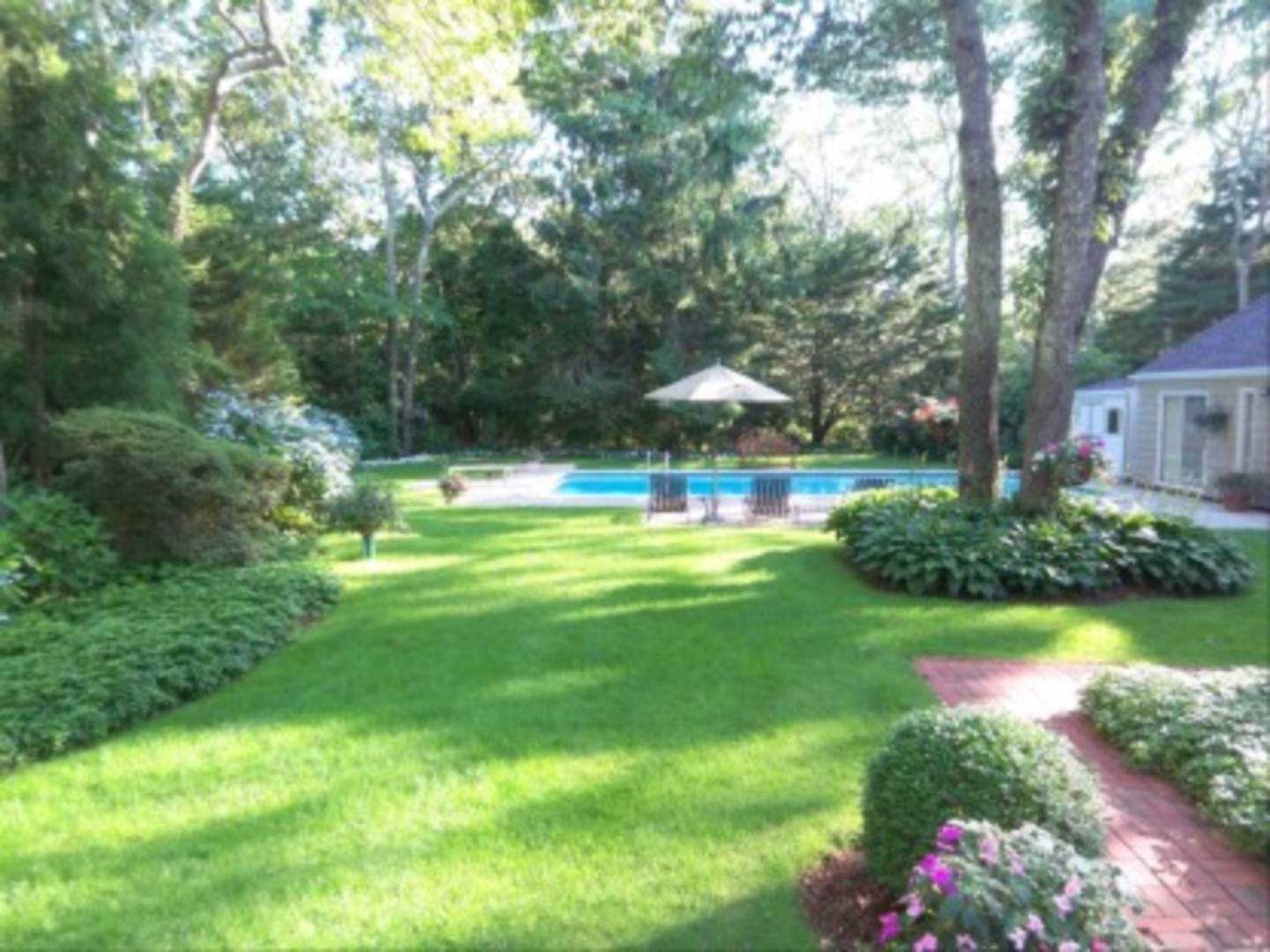 182 Cove Hollow Road East Hampton, NY 11937 - Photo 11 of 14 a view of yard with swimming pool and green space