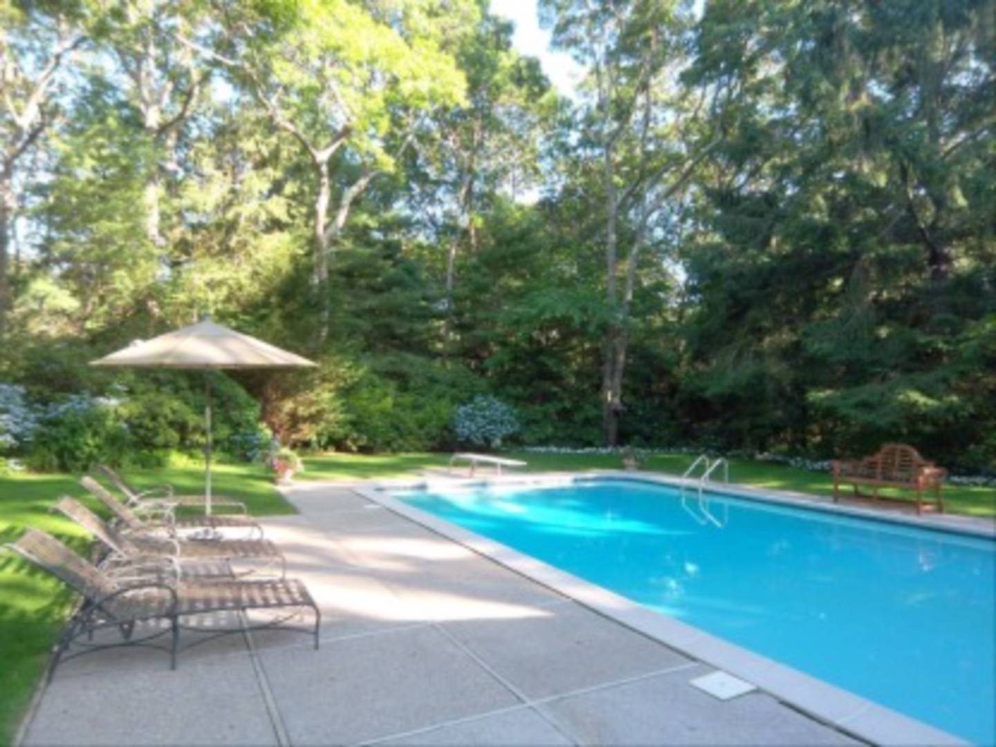 182 Cove Hollow Road East Hampton, NY 11937 - Photo 13 of 14 a view of a swimming pool with a patio